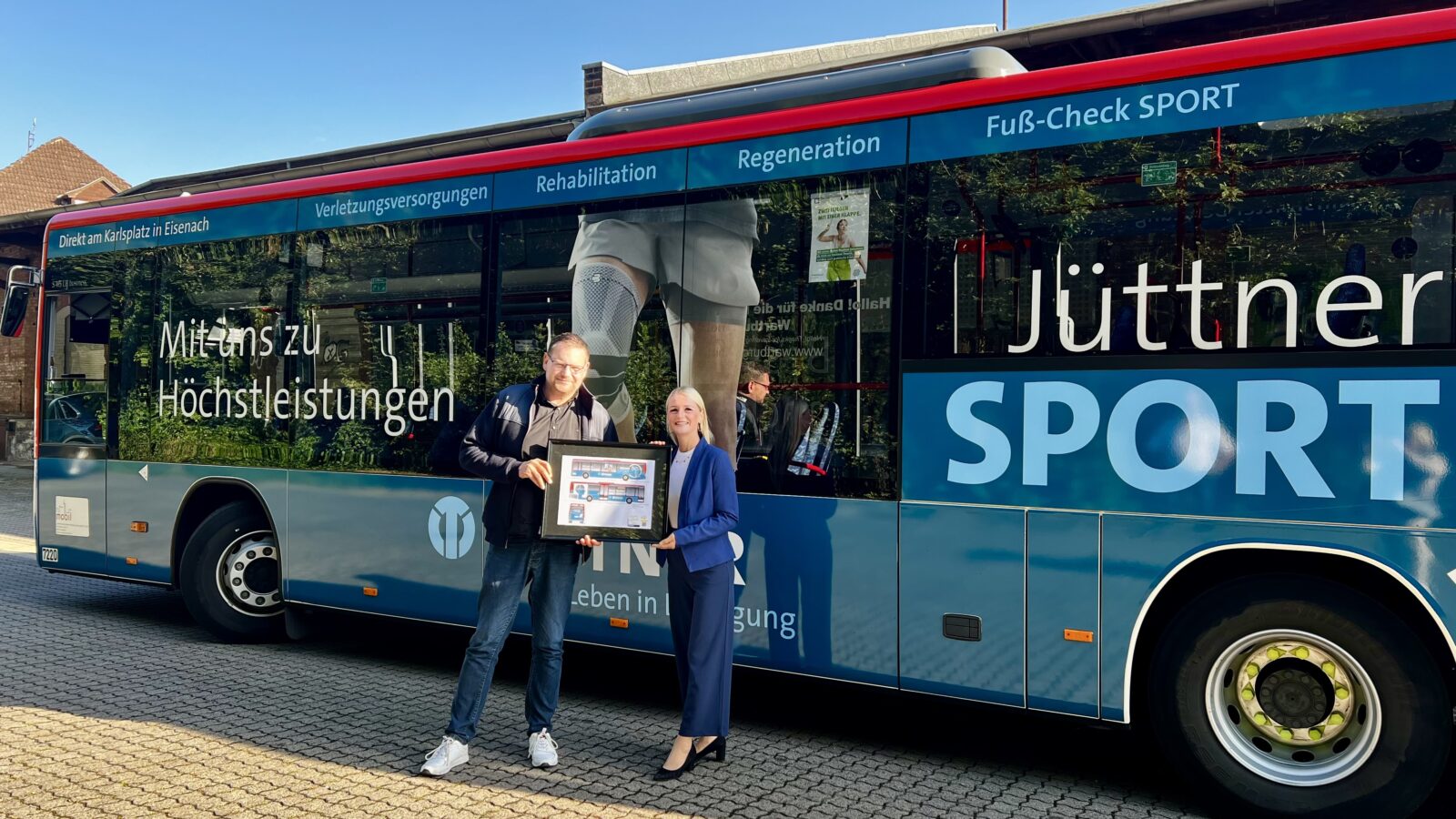 Zwei Personen stehen vor dem Bus von Jüttner Orthopädie 